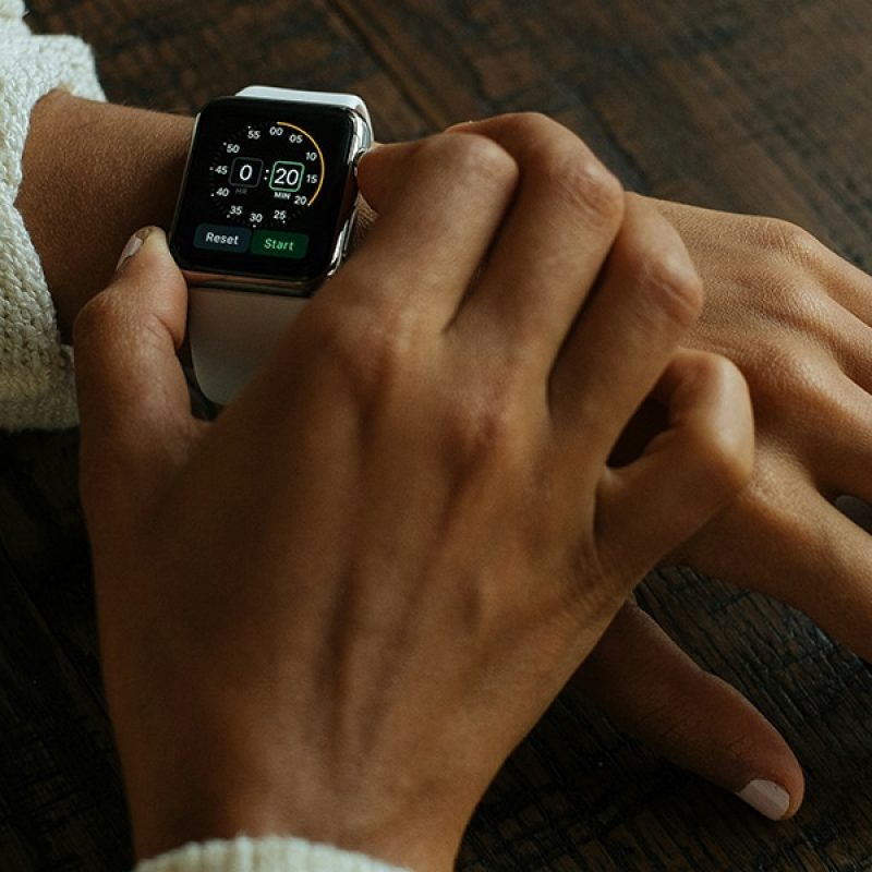 hand setting the time on a watch