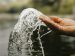 hand splashing water from a river