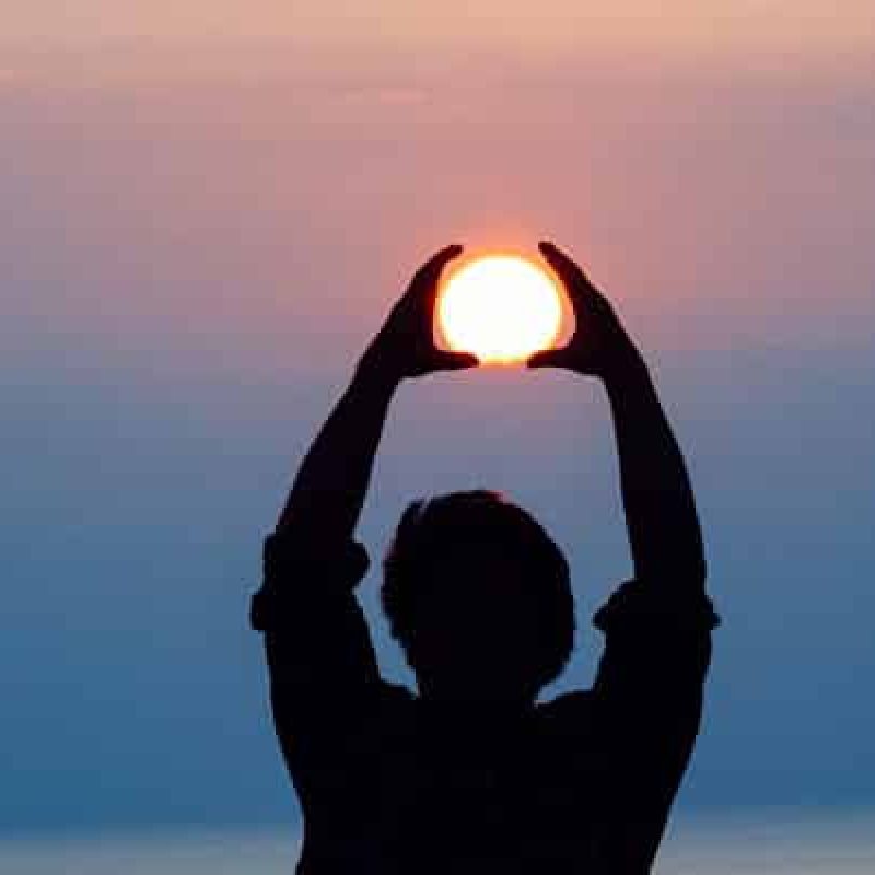 hands raised to the sun