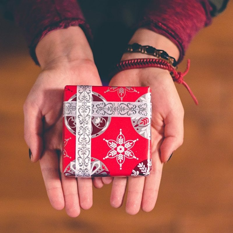 open hands holding a gift to give to someone else.