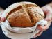 hands holding a fresh loaf of bread