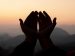 hands peaceful in worship with a sunrise in the background