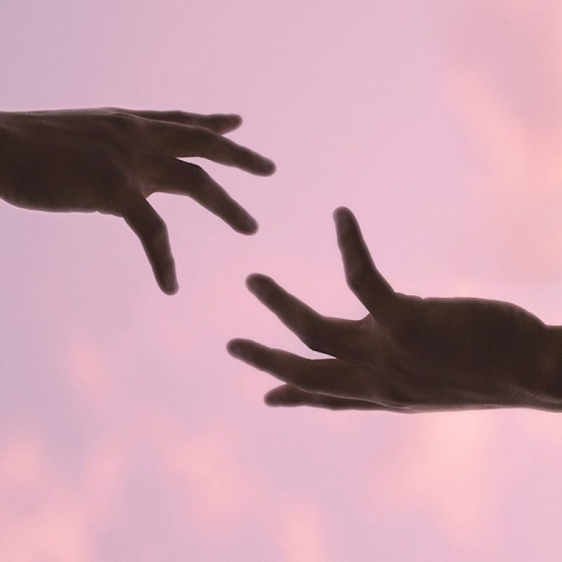 hand reaching out to help other hand