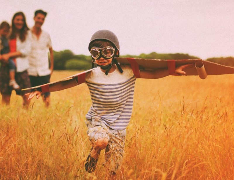 kid with wings pretends to fly