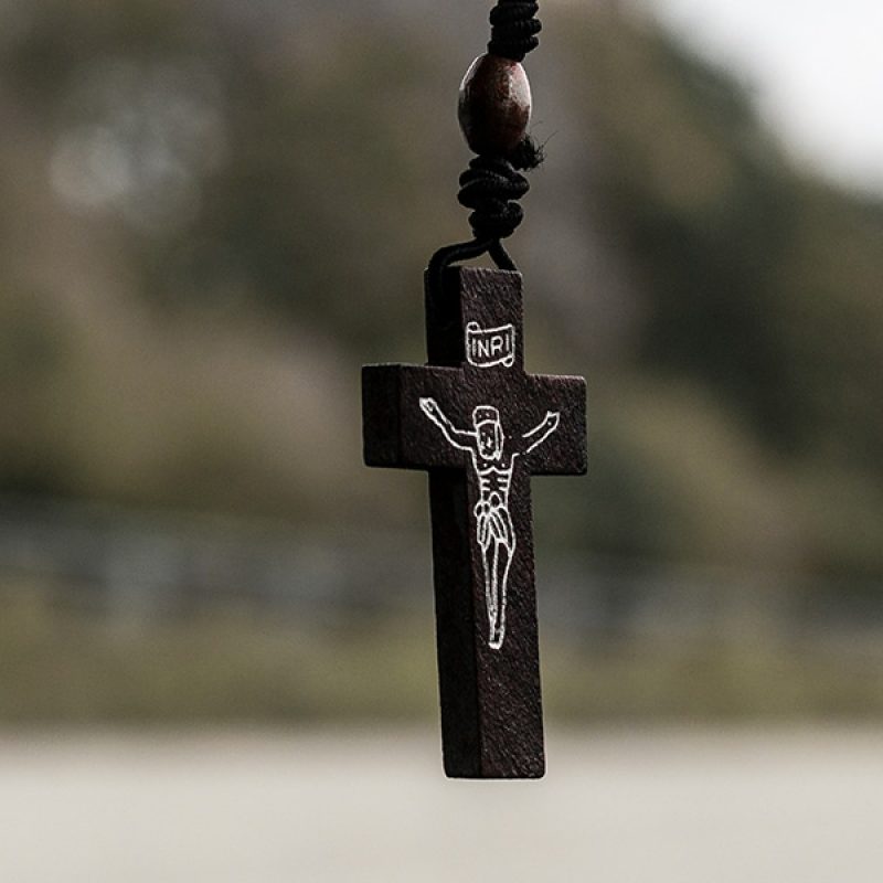 Small crucifix with Jesus hanging from a car mirror