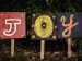 Three signs spelling out the word joy