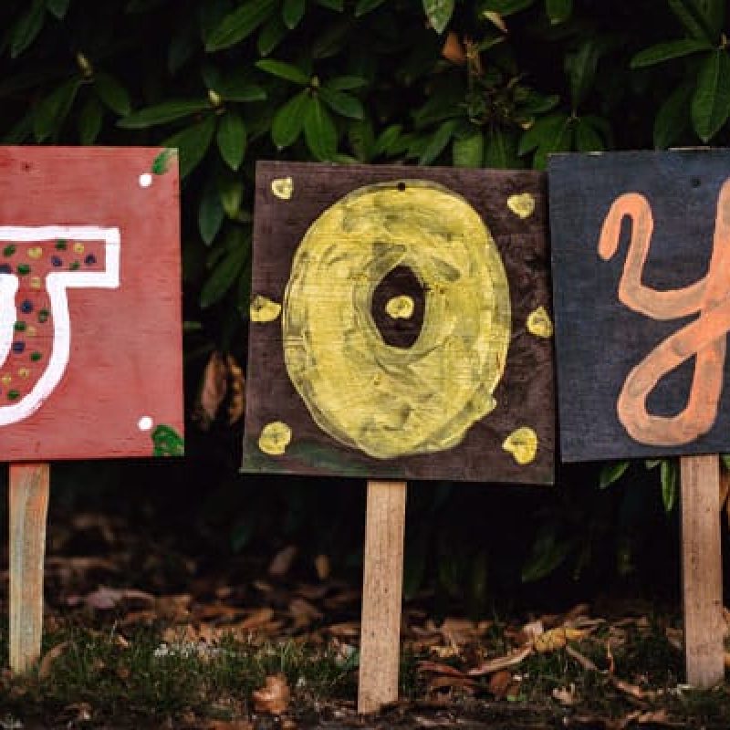 Three signs spelling out the word joy