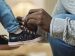 man tying a kid's shoe
