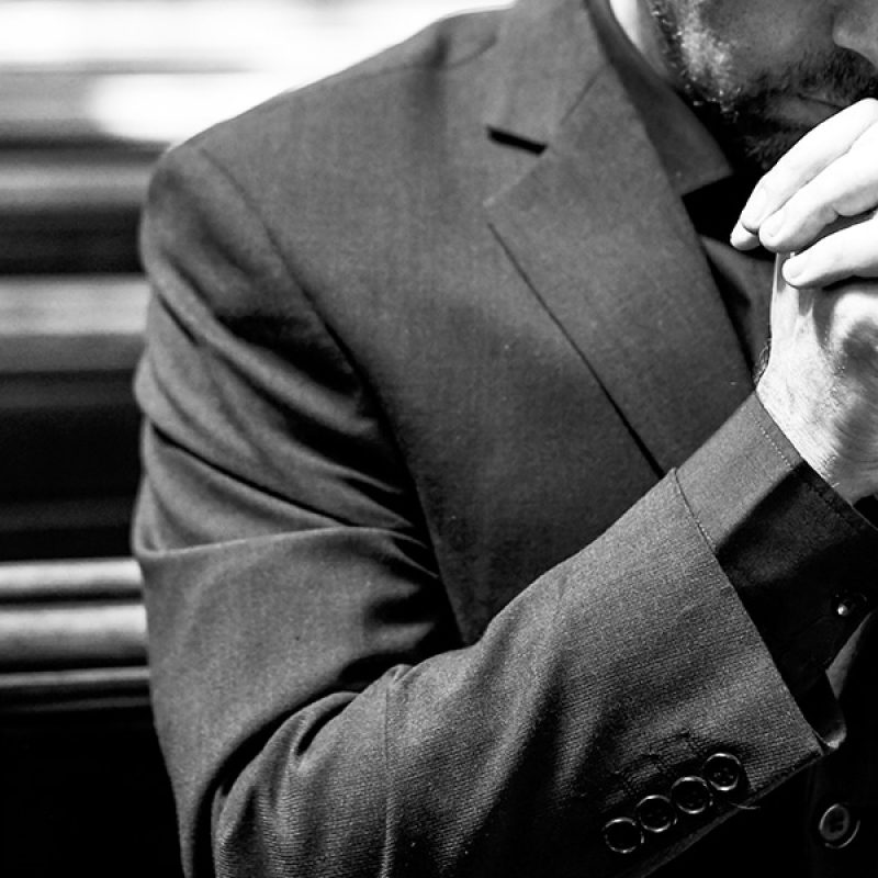 man praying in a church.