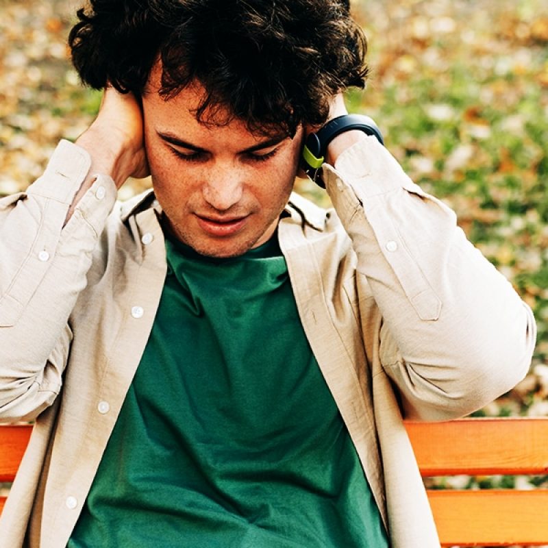 young man holding his ears closed
