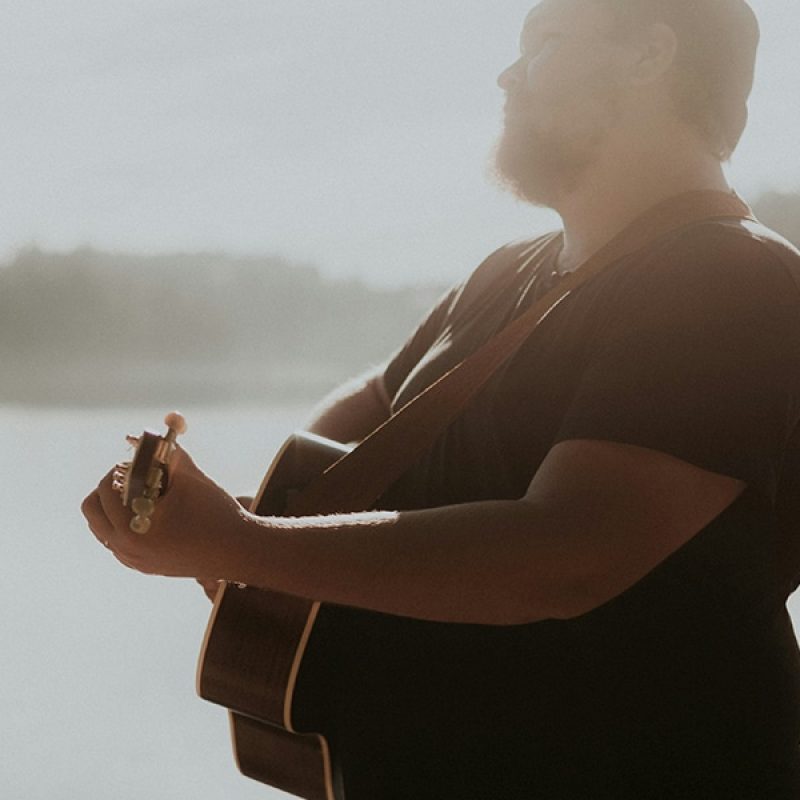 man playing guitar and singing