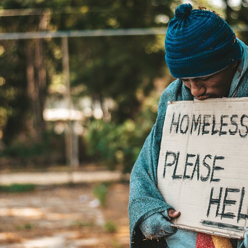 A homeless man with a sign.