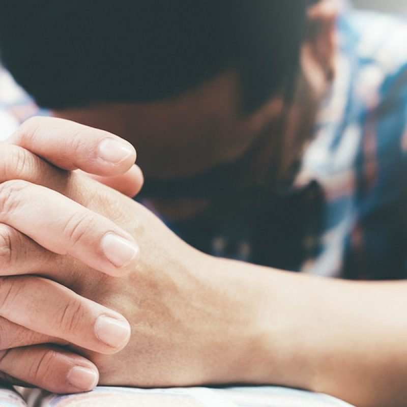 man_praying_hands Man praying with hands folded.