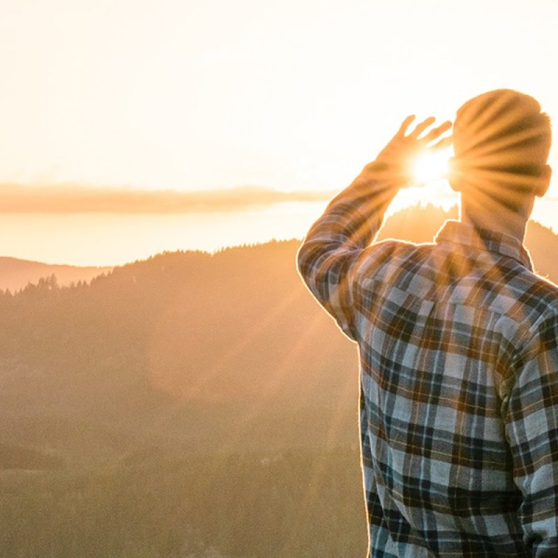 man watching a sunrise surrounded by Sundays
