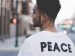 man wearing a t-shirt with the word Peace on the back.