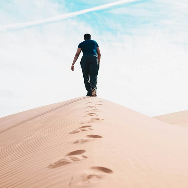 man walking in the desert
