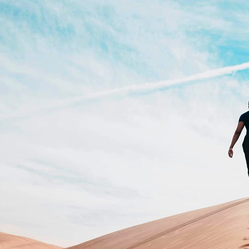 Man walking in the desert.
