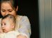 A mother holding her baby in her arms
