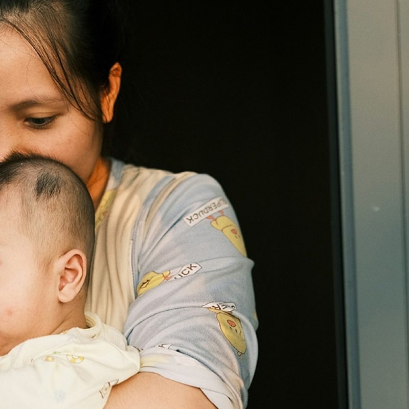 A mother holding her baby in her arms