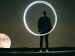 person drawing a circle with light in the dark.