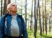 Older person walking outside in a forest