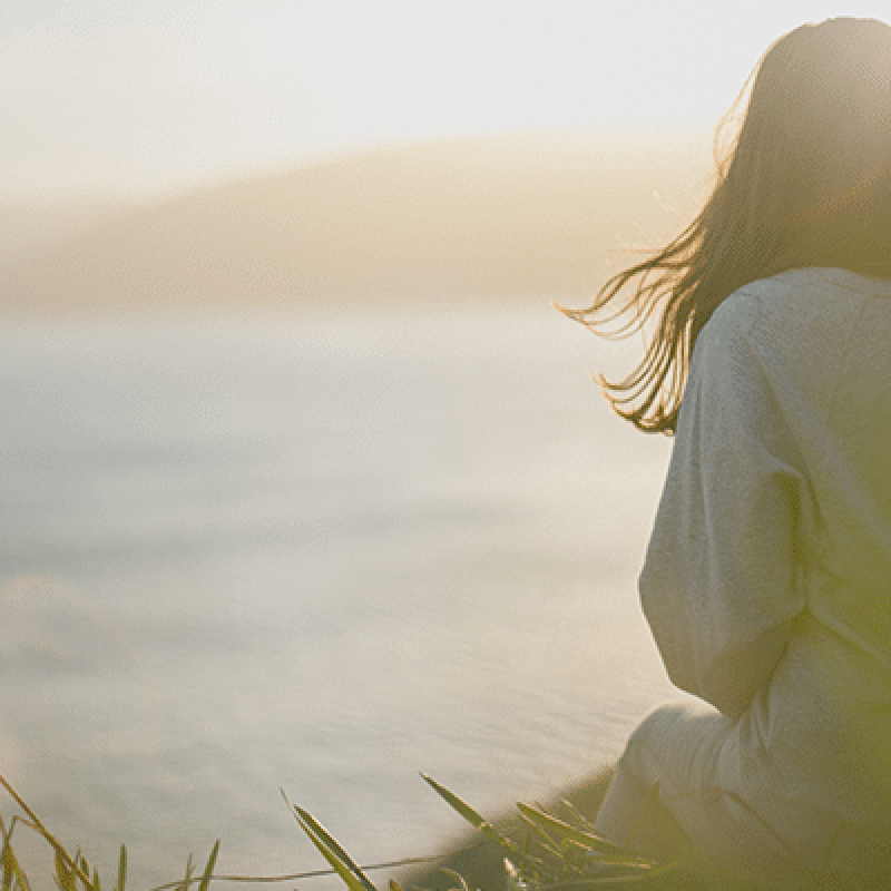 peaceful Woman sitting by water, peaceful