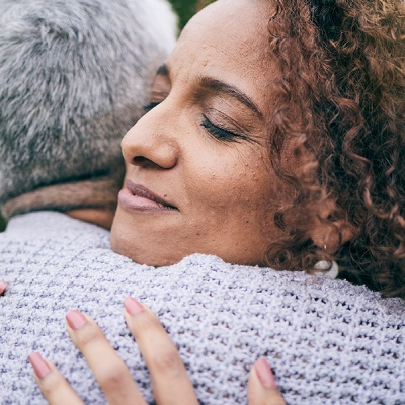 two people in a warm embrace of forgiveness