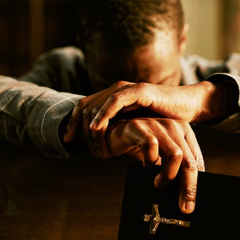 person praying and repenting