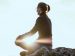 person sitting peacefully on a rock while meditating