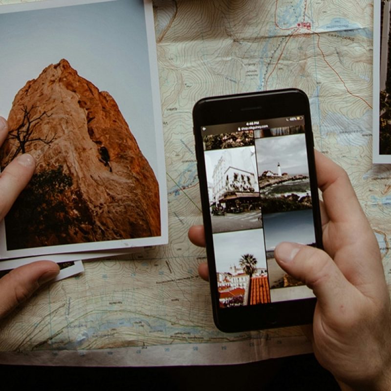 hands holding phone, surrounded by photos