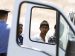 An Italian policeman watches as immigrants board a van after they disembarked from an Italian coast guard boat at the port in Lampedusa, Italy, July 9. The day before in Lampedusa, Pope Francis lamented the sufferings of people who flee their homeland and mourned those who have died doing so. The island has been a landing point for scores of immigrants from Africa attempting to make their way to Europe. (CNS photo/Paul Haring) (July 9, 2013)