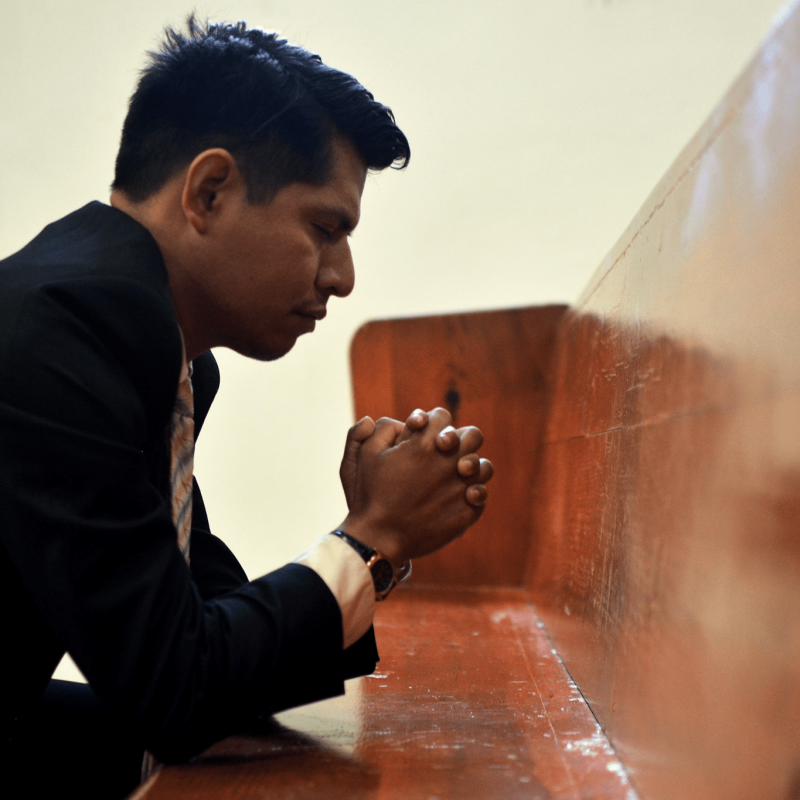 man kneeling in prayer