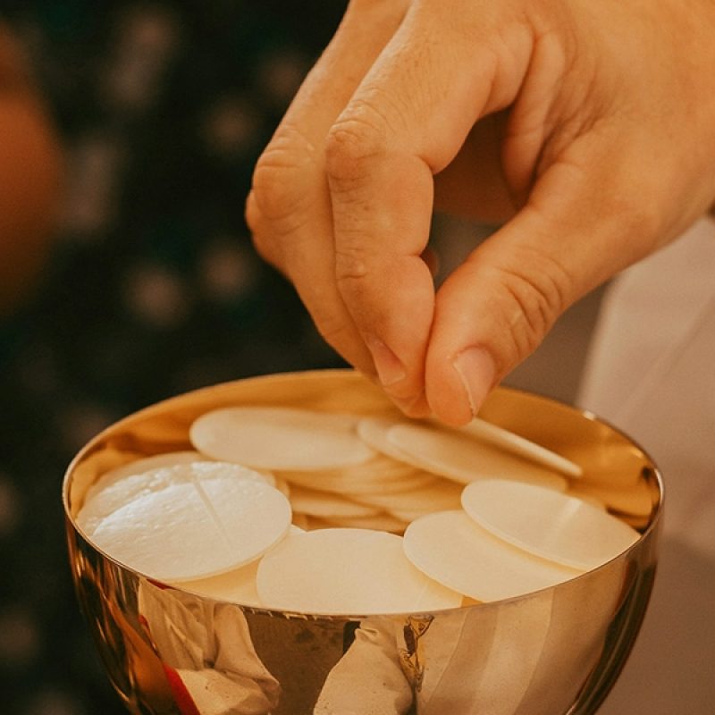 Priest handing out communion.