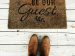 shoes standing in front of a welcome mat with the words "Be Our Guest"