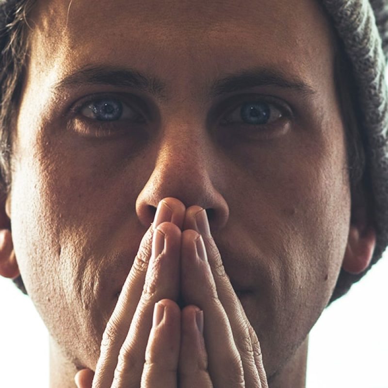 Man praying | Photo by Luke Downing on Unsplash