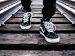 shoes on train tracks taking the next step.