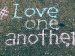 surrender to love; "love one another" written in chalk on the sidewalk; Jon Tyson/Unsplash