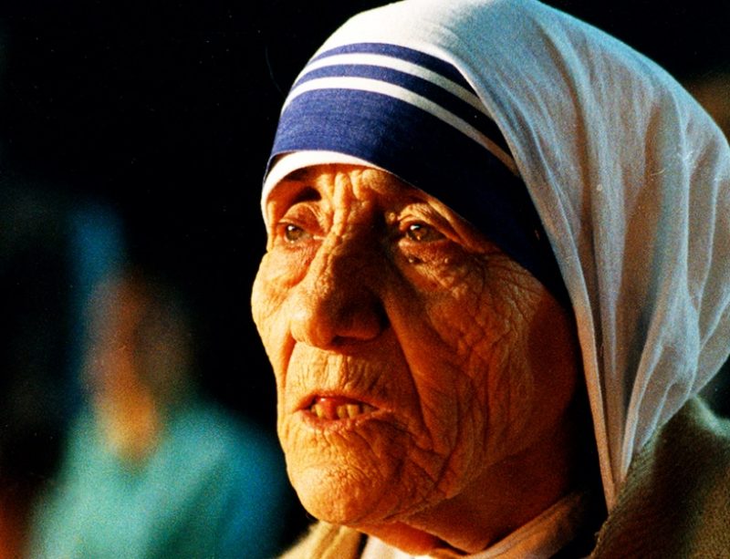 Mother Teresa praying by candle light