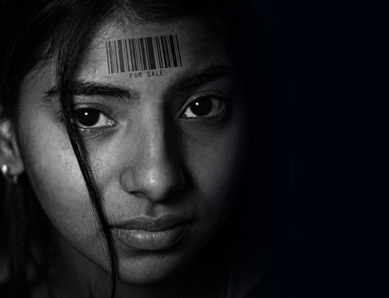young girl with a barcode on her forehead