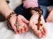 two different hand holding each a rosary