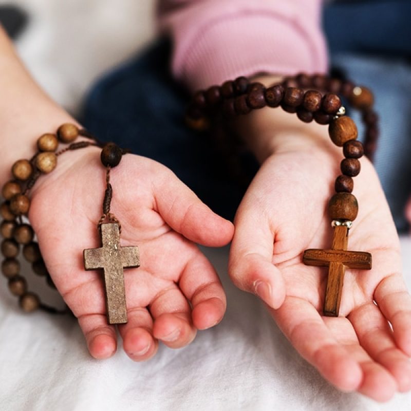 two different hand holding each a rosary