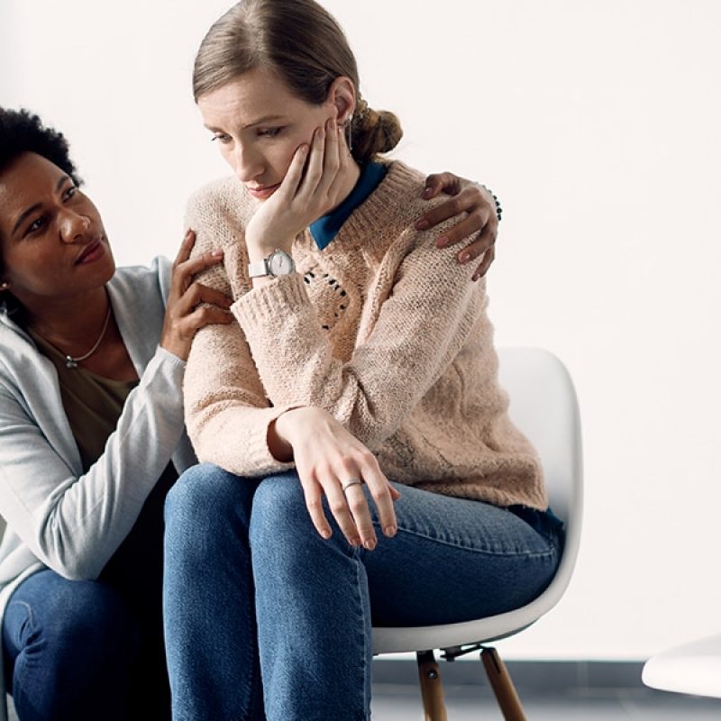 two_woman_compassion One woman comforting another woman and showing compassion