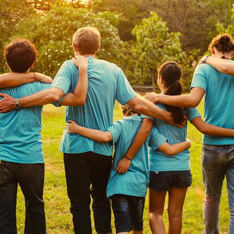 A group of volunteers in solidarity embracing each other.