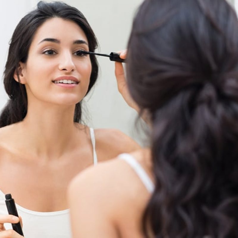Woman applying makeup