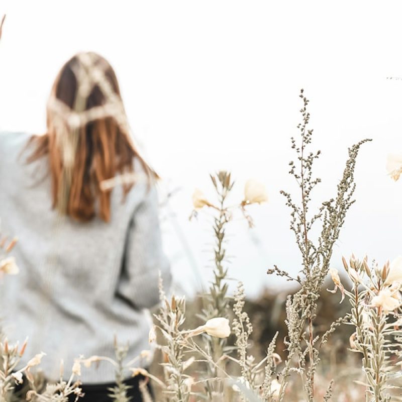 Woman in a field | Photo by Jasmin Ne on Unsplash