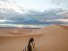 woman-sitting-alone-on-a-sand-dune