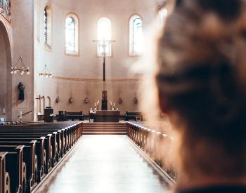 Woman at the back of church