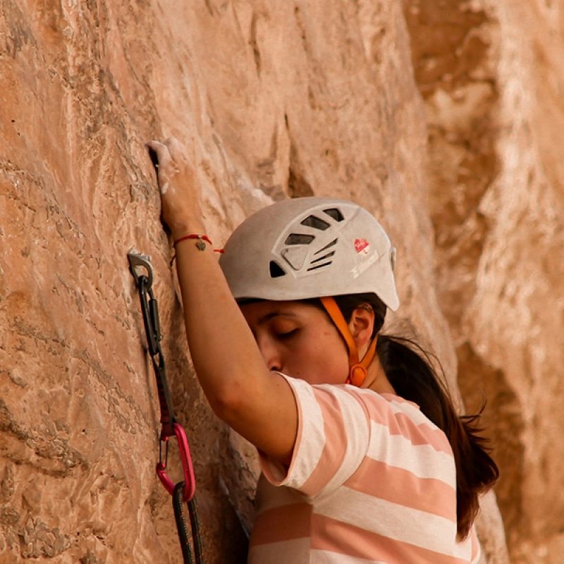 woman courageously rock climbing