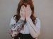 woman covering her face with her hands