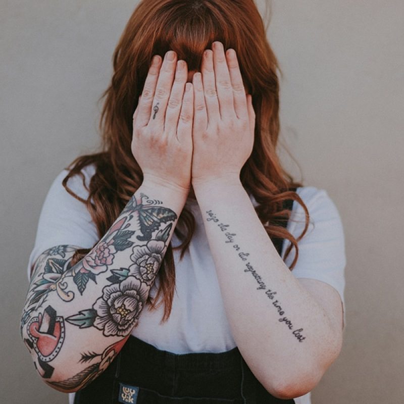 woman covering her face with her hands